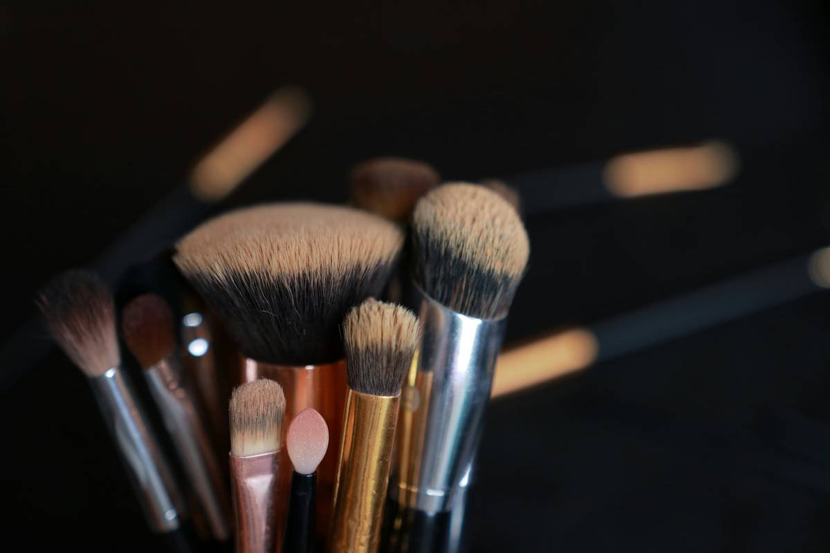 Side-by-side comparison of foundation applied with dry sponge, damp sponge, synthetic brush, and fingers showing finish differences
